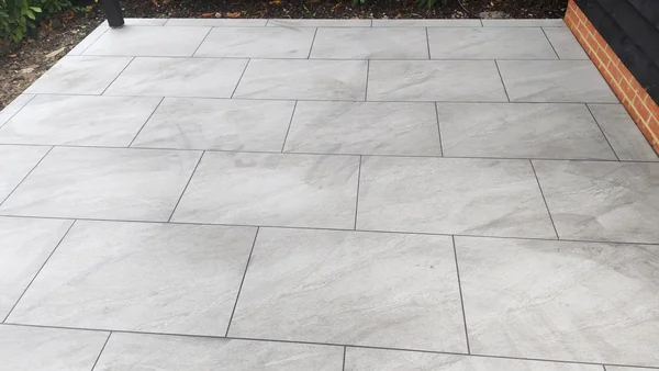 Terrace laid to fall — Drainage channel set flush to the threshold